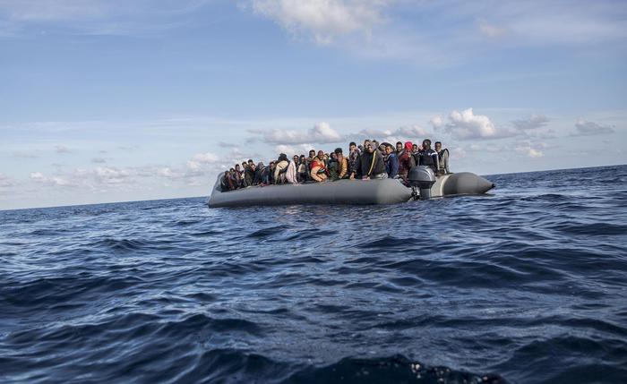 In this Friday, Dec. 21, 2018, photo, migrants sit in a rubber dinghy after Proactiva Open Arms, a Spanish NGO, spotted and rescued them in the Central Mediterranean Sea at 45 miles (72 kilometers) from Al Khums, Lybia. The Spanish NGO Open Arms have rescued about 300 migrants from 3 boats crossing the Mediterranean from North Africa to Europe on Friday. (ANSA/AP Photo/Olmo Calvo) [CopyrightNotice: Copyright 2018 The Associated Press. All rights reserved.]